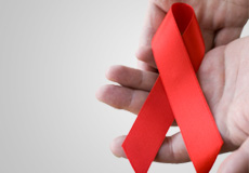 AIDS-Schleife Abgebildet ist eine rote Schleife – das Symbol der Solidarität mit HIV-Infizierten und AIDS-Erkrankten.