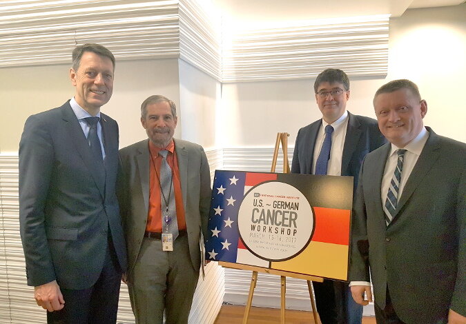 Gruppenfoto vor einem Aufsteller zum Cancer Moonshot Workshop