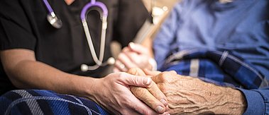 Hospizschwester besucht einen älteren männlichen Patienten