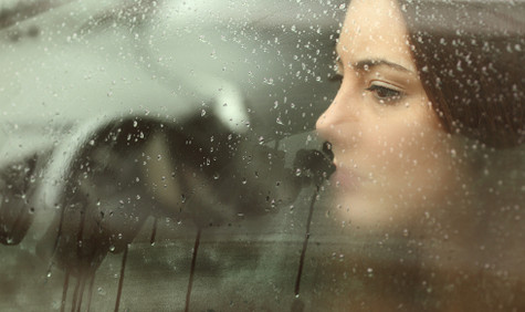 Psychotherapeutische Sprechstunde (Bildquelle: Antonio Guillem/Shutterstock.com) Foto: Eine junge Frau sitzt bei Regen in einem Auto und schaut nachdenklich in den Regen