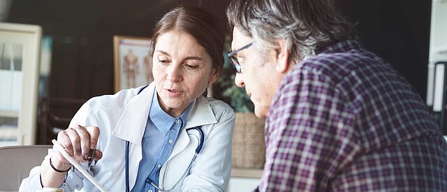 Ärztin im Gespräch mit Patient