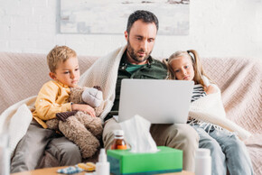 Ein Vater im Homeoffice mit seinen Kindern