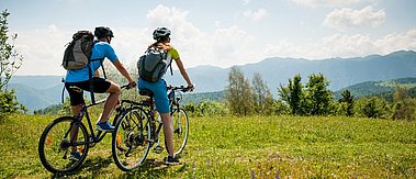 Ein junges Paar auf Fahrrädern auf einer Wiese