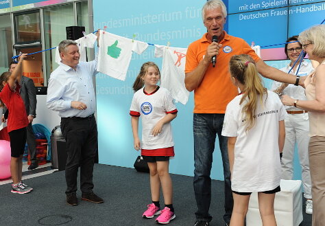 Minister Gröhe und Dr. Heidrun Thaiss hängen Wäsche auf.