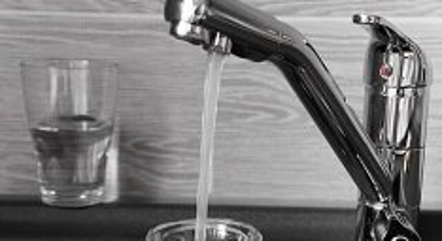 Photo: Water flowing from a tap into a vessel.