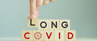 Long covid, post covid concept. Long-term effects of coronavirus. Chronic fatigue or weakness, feeling tired easily. Medical, treatment for long covid symstoms, tips for recovery..Wooden cube blocks.