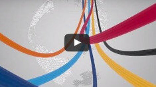 Screenshot of a film screen with a globe and coloruful ribbons flowing towards the viewer